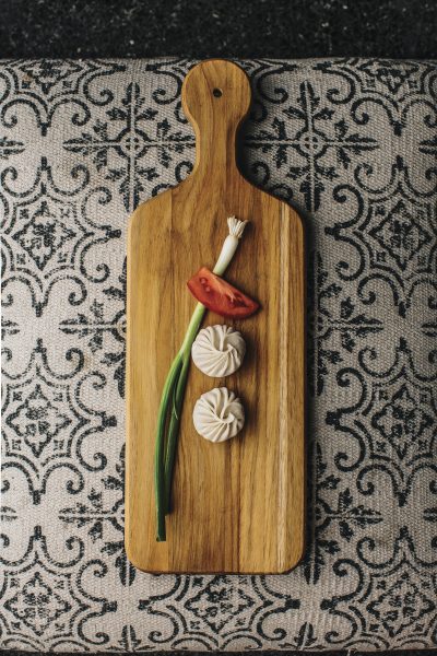 two momos on wood serving board