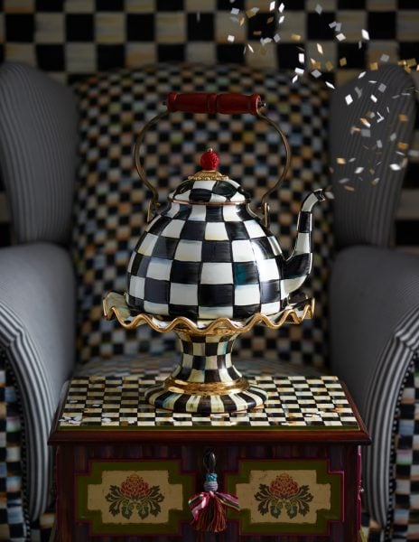 Artistic checkered teapot on decorative table 