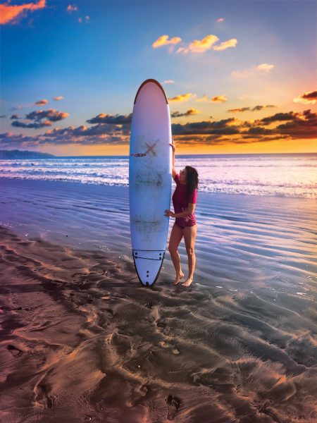 Jillian Dunn with surfboard on beach